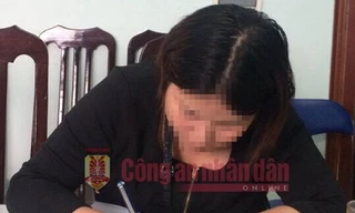 Chị N viết tường trình tại cơ quan Công an. Ảnh: CAND.