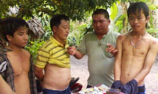 Ba đối tượng (cởi trần, bị còng tay) và tang vật