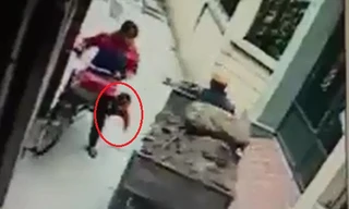 Giây phút bé trai ngã xuống đường suýt bị công nông cán