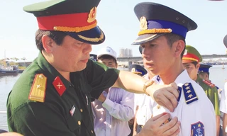 Thiếu tá Thái Đức Hạnh trao Huy hiệu “Tuổi trẻ dũng cảm” cho thuyền trưởng Thượng úy Lê Trung Thành. Ảnh: Nguyễn Huy.