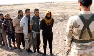 Các chiến binh IS xếp hàng đầu thú. Ảnh: RT