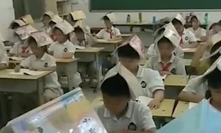 Học sinh Trung Quốc đội sách lên đầu để “tránh tư thế ngồi xấu” gây tranh cãi nảy lửa
