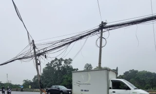 Vì sao hàng cột điện nghiêng ngả giữa QL 1 qua Hà Nội chưa thể di chuyển? 