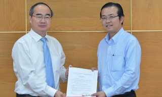 Đồng chí Nguyễn Thiện Nhân, Ủy viên Bộ Chính trị, Bí thư Thành ủy TPHCM, trao quyết định điều động, bổ nhiệm cho đồng chí Lê Văn Minh. Ảnh: VIỆT DŨNG.