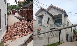 Hình ảnh con đường bị sụt sâu xuống 3-4m cùng ngôi nhà bị lún (Ảnh: Nguyễn Kim Tuấn/Vietnam+)