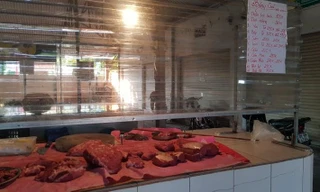 Quầy thịt bò tại chợ Quán Tình (Long Biên, Hà Nội) niêm yết công khai bảng giá hằng ngày trên tấm nilong ngăn giữa người bán và người mua. Ảnh: Ngọc Mai