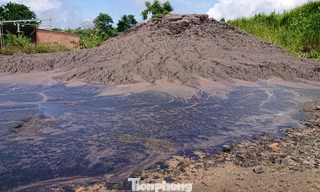 Sau cơn mưa, lượng nước màu đen từ chất thải đổ lênh láng trên nền đất