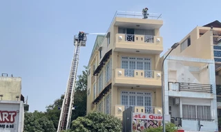 Lính cứu hỏa điều xe thang dập lửa, giải cứu người mắc kẹt.