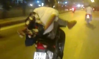 Thanh niên cởi áo, lái xe bằng một chân