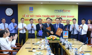 Ông Tô Mạnh Cường, Tổng giám đốc Tổng công ty Viễn thông MobiFone (ở giữa, bên trái) và Ông Phạm Anh Đức, Tổng giám đốc Tổng công ty Bảo hiểm PVI (ở giữa, bên phải) ký kết Thỏa thuận hợp tác
