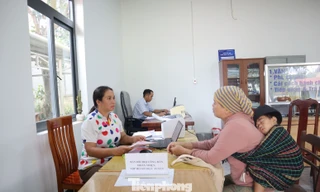 Cán bộ xã dùng song ngữ giúp dân làm thủ tục hành chính