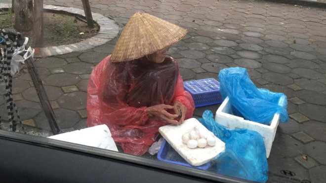 Cụ bà đội mưa bán trứng bên vỉa hè khiến nhiều người xúc động.