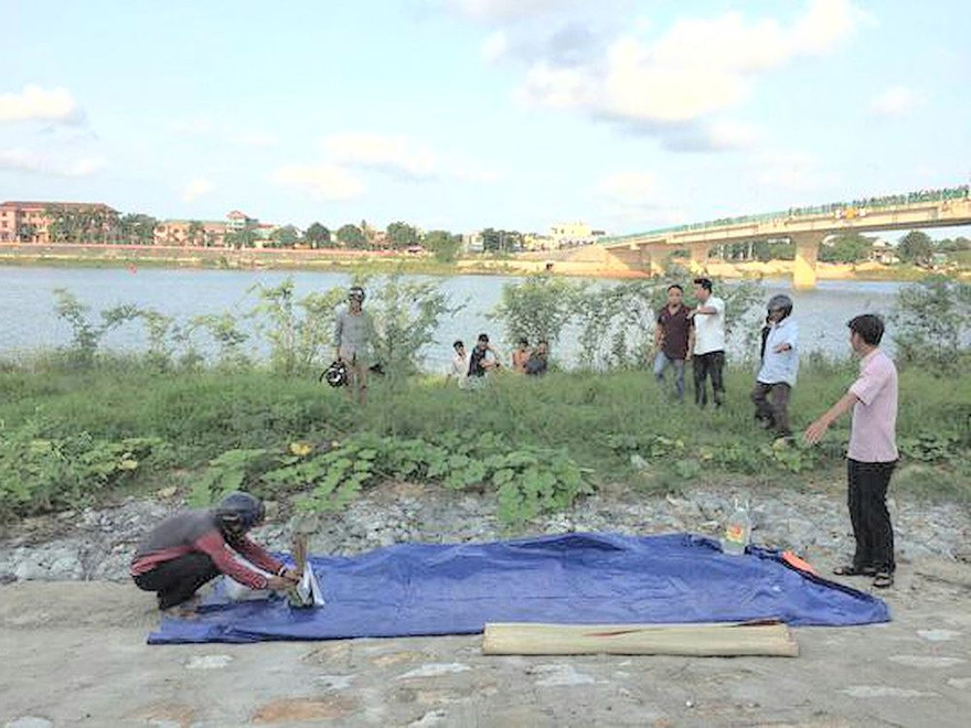 Nhóm cứu hộ đưa thi thể nam sinh Thái Thanh Phong lên bờ. Ảnh: H.Thơ