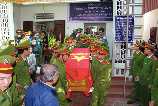 Đồng đội, người thân tiễn đưa đại uý Nguyễn Tuấn minh về nơi an nghỉ - Ảnh: LP