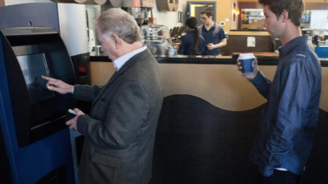 Người dân đợi xếp hàng đợi giao dịch tại ATM Bitcoin đầu tiên của thế giới ở Canada.