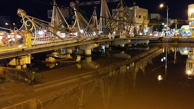 Nước dưới sông Maspéro đang dâng cao và sà lan và xe cẩu đã chìm. Ảnh: Việt Tường.