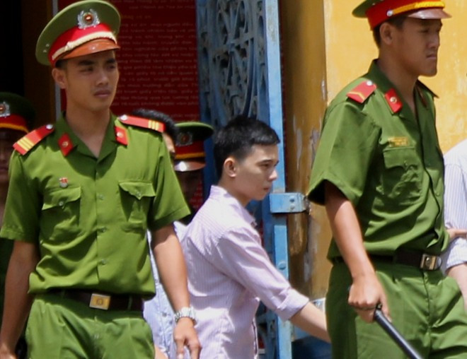 Triều bị dẫn giải sau phiên tòa.