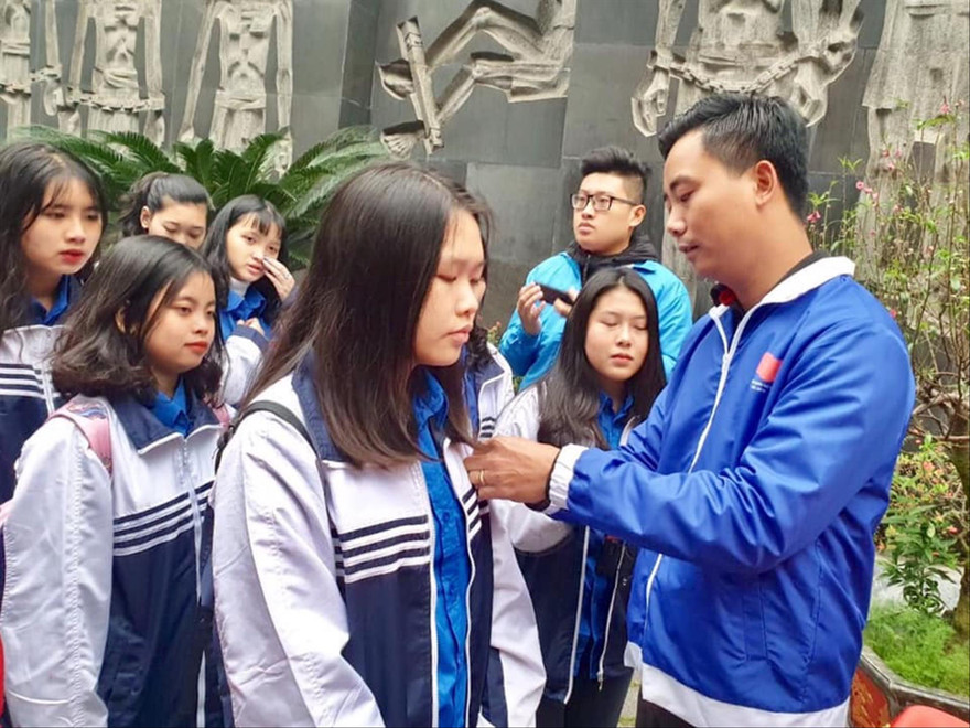 Anh Nguyễn Đức Tiến, Phó Bí thư Thành Đoàn, Chủ tịch Hội LTHN TP Hà Nội trao Huy hiệu Đoàn cho các đoàn viên mới được kết nạp, tại Khu Di tích Hỏa Lò Ảnh: CTV 