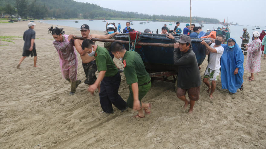 Khẩn trương di chuyển thuyền gắn máy, thuyền thúng lên bờ tránh bão tại biển Đà Nẵng. Ảnh: Nguyễn Thành