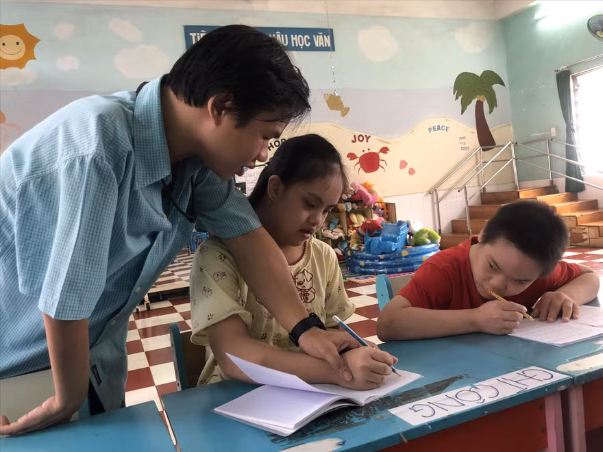 Anh Huỳnh Thiên Lý dạy chữ cho các em khuyết tật
