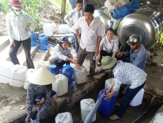 Lấy nước suối cống Kẹp. Ảnh: Báo Gia đình xã hội