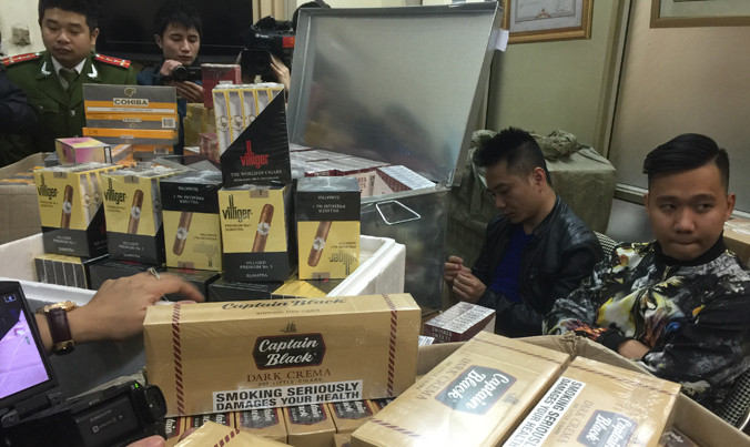 Đối tượng và tang vật một vụ buôn lậu thuốc lá ngoại số lượng lớn bị Công an Hà Nội bắt giữ.