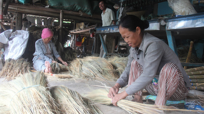 Bà Nguyễn Thị Mỹ (53 tuổi) chủ cơ sở sản xuất chổi Nhứt Tuấn vẫn tham gia cùng làm với nhân viên. Ảnh: H. Văn