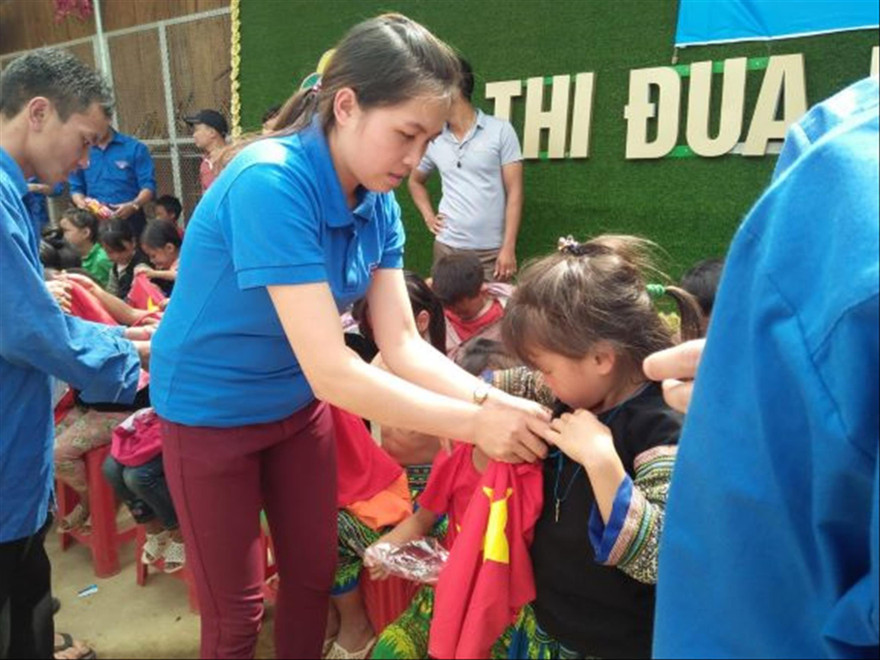 Bí thư Đoàn xã Lao Chải Lý Thị Thiêm tặng quà cho trẻ em dân tộc thiểu số Ảnh: CTV 