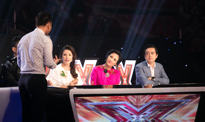 MC Thành Trung cố gắng xoa dịu màn tranh luận giữa các giám khảo. Ảnh: Windy.