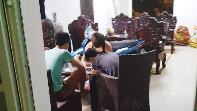 Trong một quán cầm đồ trá hình ở KTX Mỹ Đình, một nhóm sinh viên đang viết giấy cầm đồ. Ảnh: PV.
