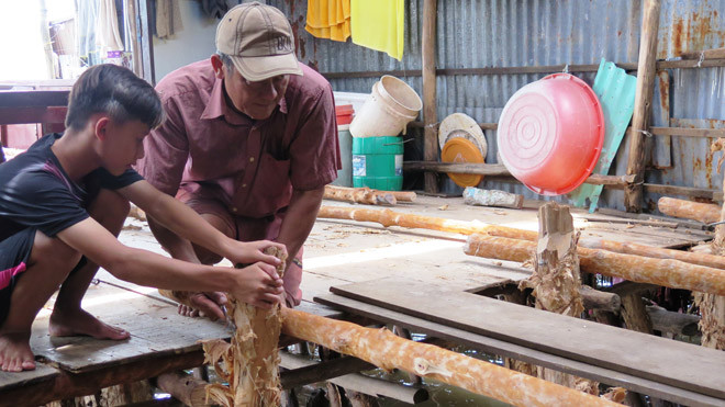 Ông Lến sửa lại nhà bị sạt lở. Ảnh: Tiến Hưng.