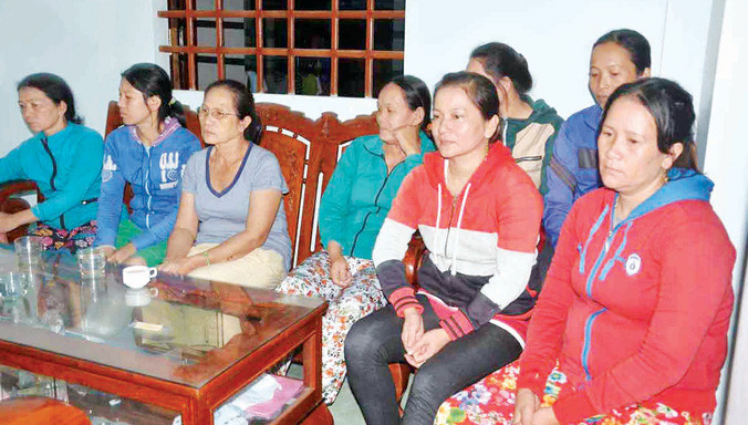 Vợ các ngư dân và bà con xóm chài đến nghe tin dữ trên biển.