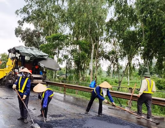 Rải thảm nhựa mặt đường cao tốc Hà Nội - Thái Nguyên giữa trời mưa.