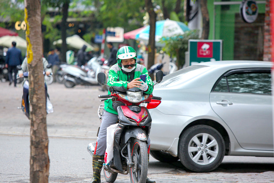 Trong lúc tranh cãi chưa được phân định, các tài xế Grab lại phải tiếp tục mưu sinh với phần thu nhập teo dần 