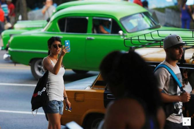 Một phụ nữ sử dụng internet thông qua điểm truy cập công cộng tại thủ đô Havana. Ảnh chụp ngày 10/7. Ảnh: Reuters.