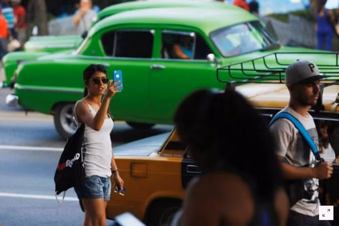 Một phụ nữ sử dụng internet thông qua điểm truy cập công cộng tại thủ đô Havana. Ảnh chụp ngày 10/7. Ảnh: Reuters.