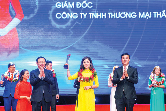 Phó Thủ tướng Vương Ðình Huệ và Bí thư thứ nhất T.Ư Ðoàn Lê Quốc Phong trao khen thưởng cho doanh nhân trẻ khởi nghiệp xuất sắc năm 2018. (Trong ảnh là nữ doanh nhân Chế Thị Hoài Thanh, Giám đốc Cty TNHH Thương mại Thắng Thanh). Ảnh: Xuân Tùng.