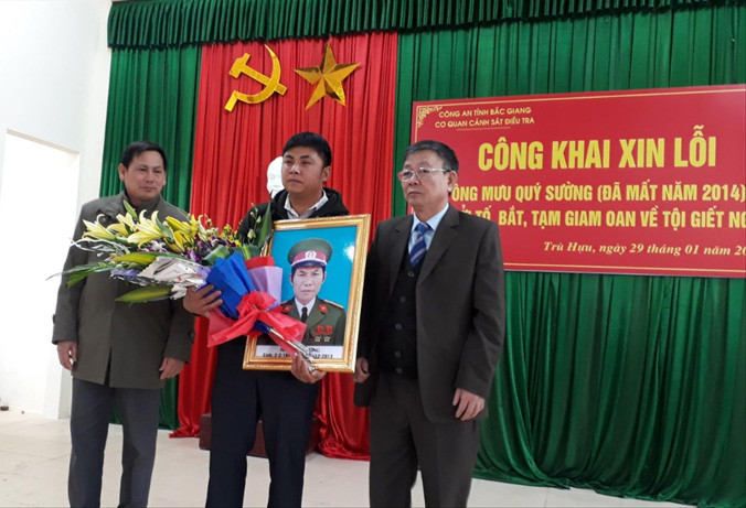 Đại diện gia đình ông Mưu Quý Sường tiếp nhận lời xin lỗi và nhận hoa từ đại diện chính quyền địa phương.