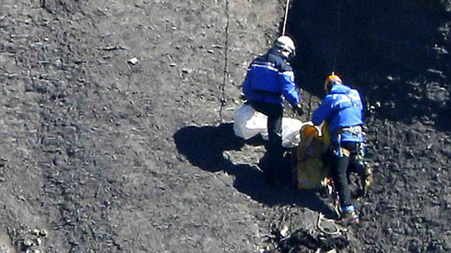 Tìm kiếm, thu gom thi thể nạn nhân. Ảnh: Reuters