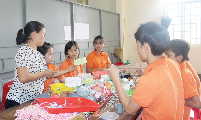 Dạy trẻ khuyết tật học nghề.