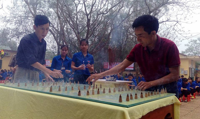 Hai cựu binh cùng học sinh trường Lê Thế Hiếu dâng trầm hương tưởng niệm các liệt sĩ Gạc Ma. Ảnh: Phạm Xuân Dũng