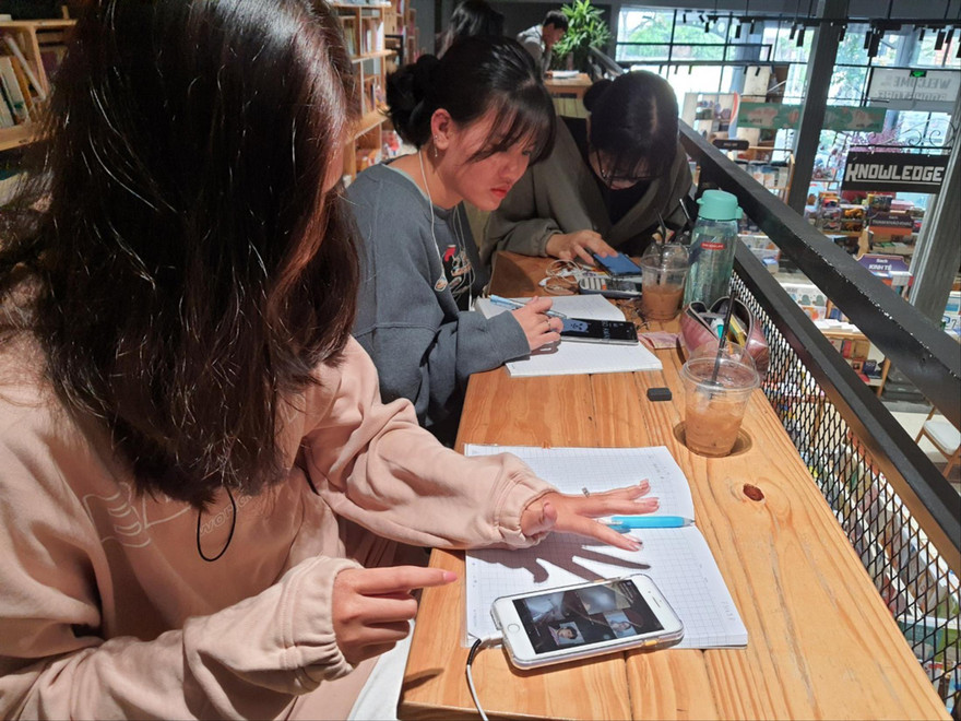 Một nhóm học sinh THPT cùng nhau học online ở nhà sách để có được wifi mạnh cũng như thuận tiện trao đổi bài