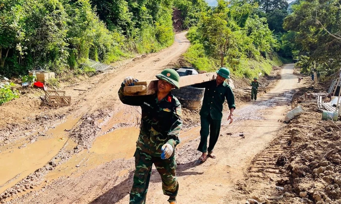 Mướt mồ hôi giúp người dân dọn bùn đất sau lũ