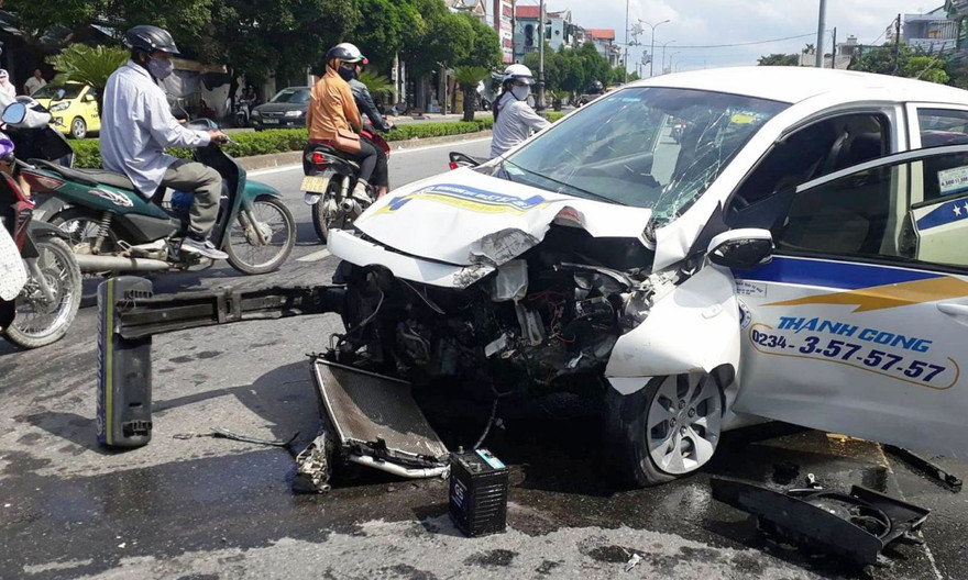 Cú va chạm mạnh với trụ đèn cao áp, dải phân cách khiến đầu xe taxi vỡ nát hoàn toàn. 
