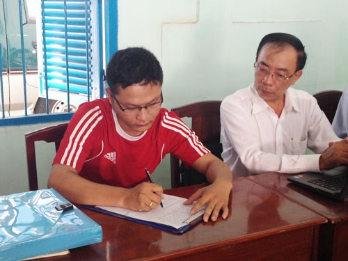 Ông Khánh ký vào biên bản làm việc - Ảnh: Minh Anh (Báo Thanh Niên)