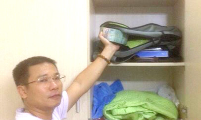 Thành lấy tiền từ nơi cất giấu giao nộp công an - Ảnh: Thanh Huyền