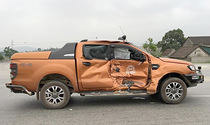 Phần thân bên phải ôtô bán tải bị lõm móp sau khi bị tông văng 10 m. Ảnh: Đ.H.