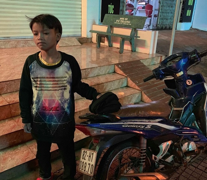 Cháu Khang và chiếc xe máy tại thời điểm được người dân phát hiện