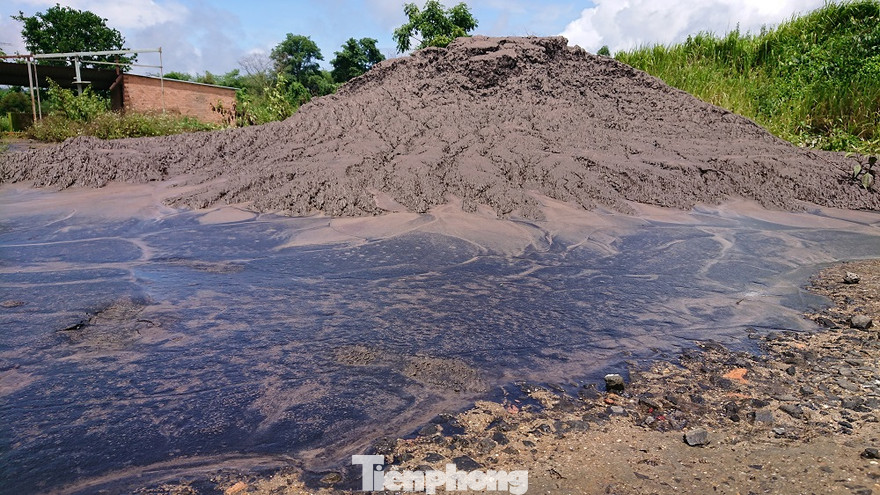 Sau cơn mưa, lượng nước màu đen từ chất thải đổ lênh láng trên nền đất