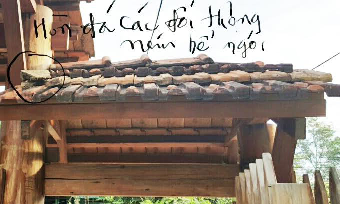 Một cục đá còn nằm trên mái ngói.